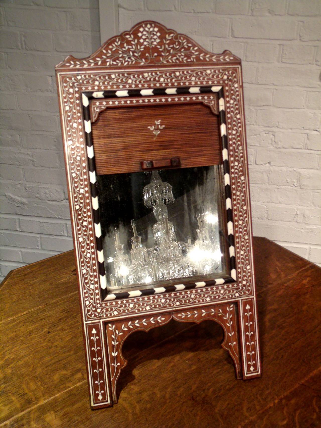 Late 19th century Moorish hardwood easel mirror. This 19th century Moorish hardwood easel mirror features a very ornate floral design inlaid with ebony and bone. The easel features a deep box back that measures 2 in–5 cm, with a tambour front also
