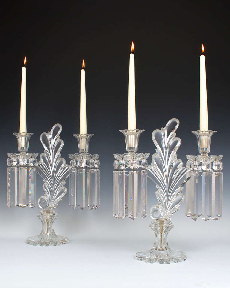 A superb quality pair of early Victorian cut-glass candelabra, the richly cut wasted and scalloped bases surmounted with an unusual glass tree centre this with two branches supporting drop hung drip pans and petal edged candle nozzles the candelabra