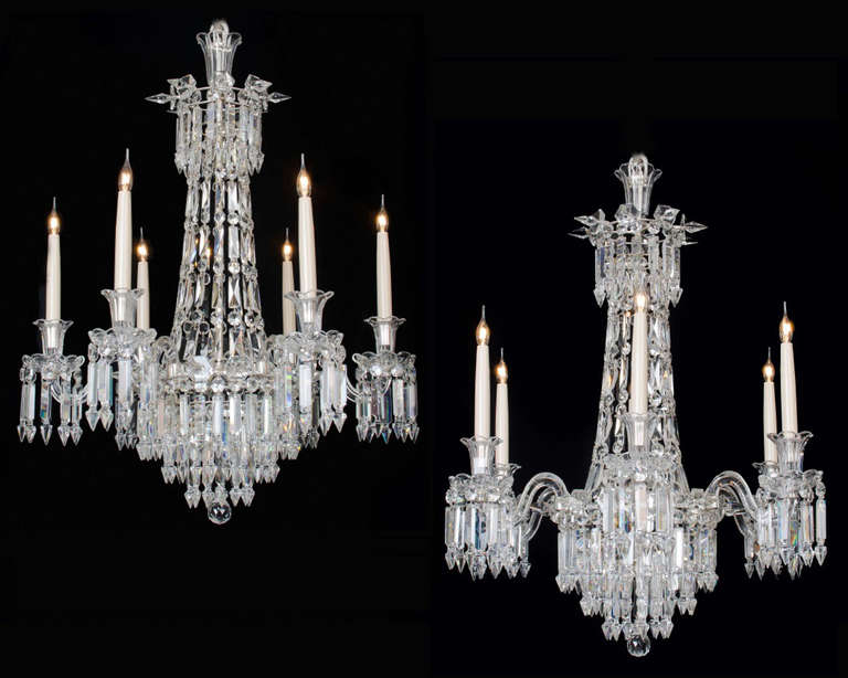 A fine quality pair of cut glass and silvered brass mounted six light chandelier of tent and waterfall design the main frame surmounted by flower rosettes, six sided candle arms with scallop edge nozzles and drip pans. All hung with plain Albert’s