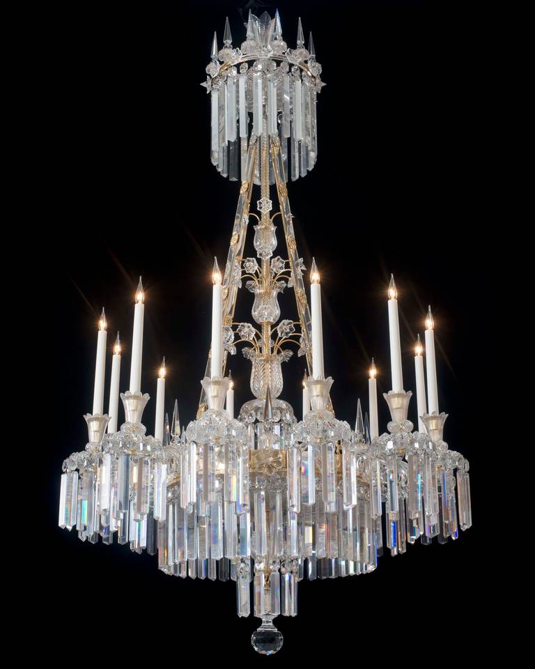 A highly important twelve-light cut-glass ormolu-mounted William IV chandelier the stem consisting of three feather cut cups supporting ormolu stems terminating with flower rosettes the main frame supporting twelve unusual bulls eye candle arms