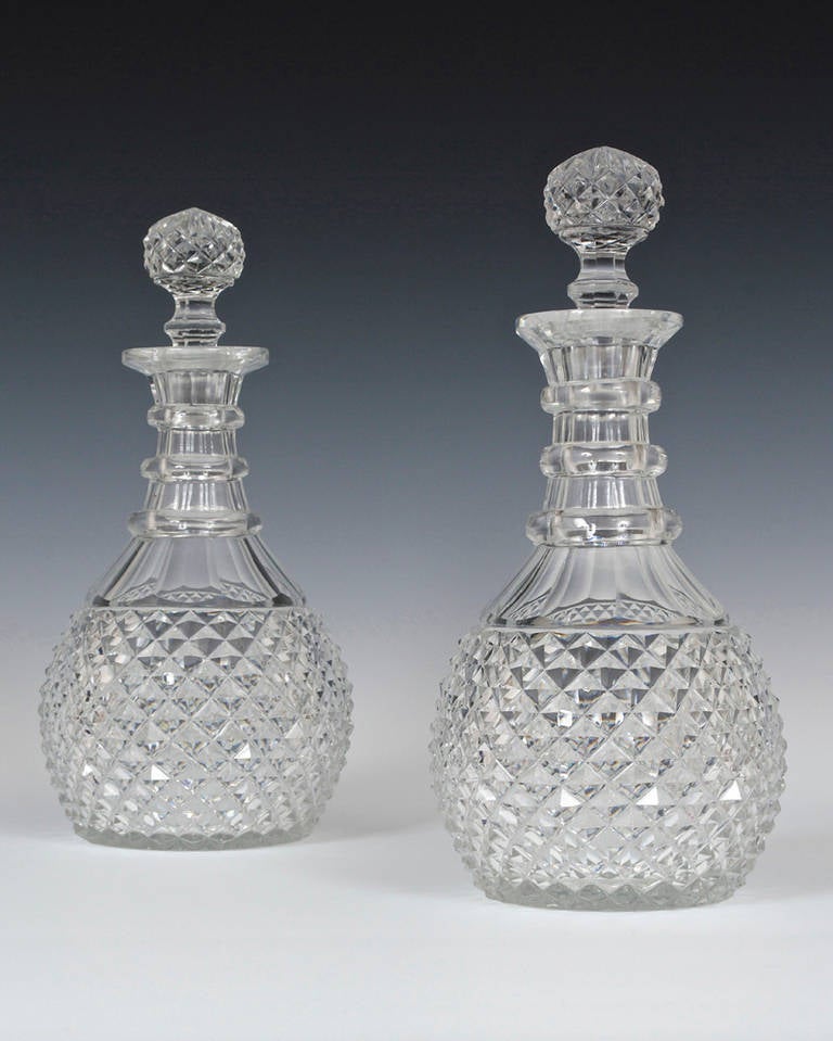 A fine pair of regency decanters with diamond cut bodes and slice cut necks fitted with diamond cut stoppers.