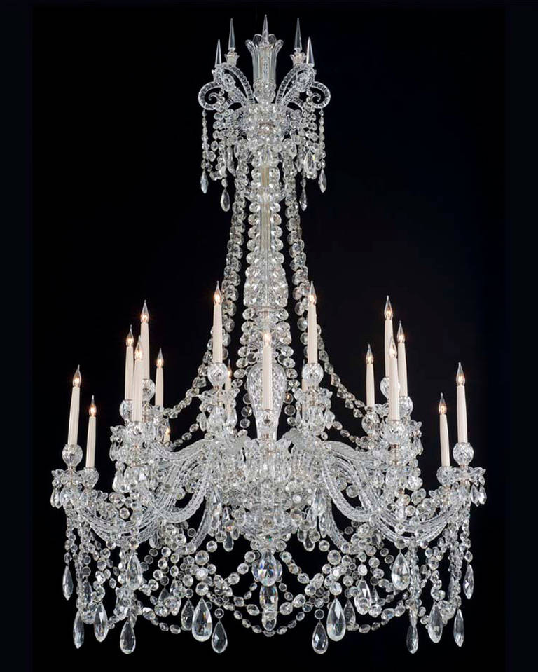 A highly important twenty-light cut-glass chandelier by F. & C. Osler, the baluster shaped shaft with cascading drapes and shepherd crooks these surmounted by spires crowning the diamond cut baluster shaft, over twenty candle arms arranged on two