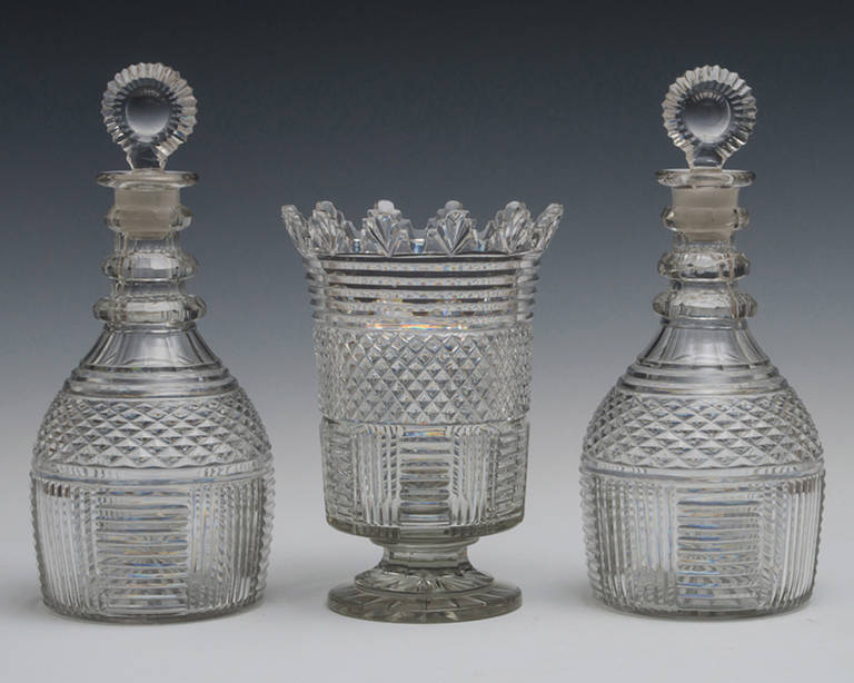 A pair of diamond and step cut panelled regency decanters with sunburst stoppers and matching vandyke vase.

Decanters height 10 1/4 (26cm),
width 4 3/4in (12cm).
 
Vase height 7 3/4in (19.5cm),
width 5 1/2in (14cm).