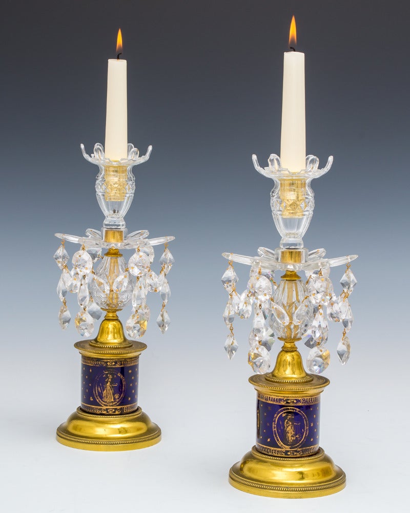 An important pair of English George III candlesticks the ormolu-mounted blue glass drums decorated with neoclassical sense of faith, hope and charity with in oval borders the drums also decorated with stars and inter laced garlands surmounted by