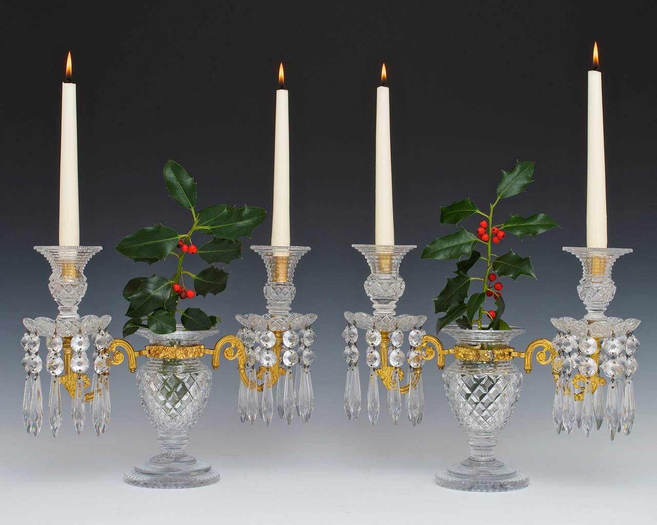 The circular stepped bases of vase form this unusually surmounted with an ormolu twin branch these supporting drip pans and thistle shaped candle nozzles these cut with fine strawberry diamonds and step cutting the candelabra hung with rounded