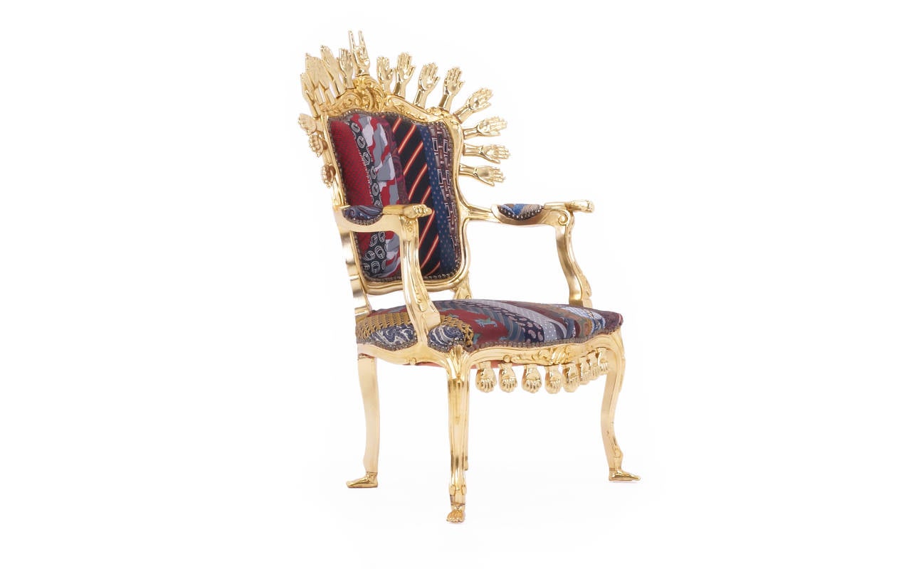 This is an extremely rare opportunity. One off chair by artist and designer Pedro Friedeberg. This stunning chair is upholstered in Mr. Friedeberg's own personal neck ties. 17 hand-carved and gold leafed hands across the top and eight across the