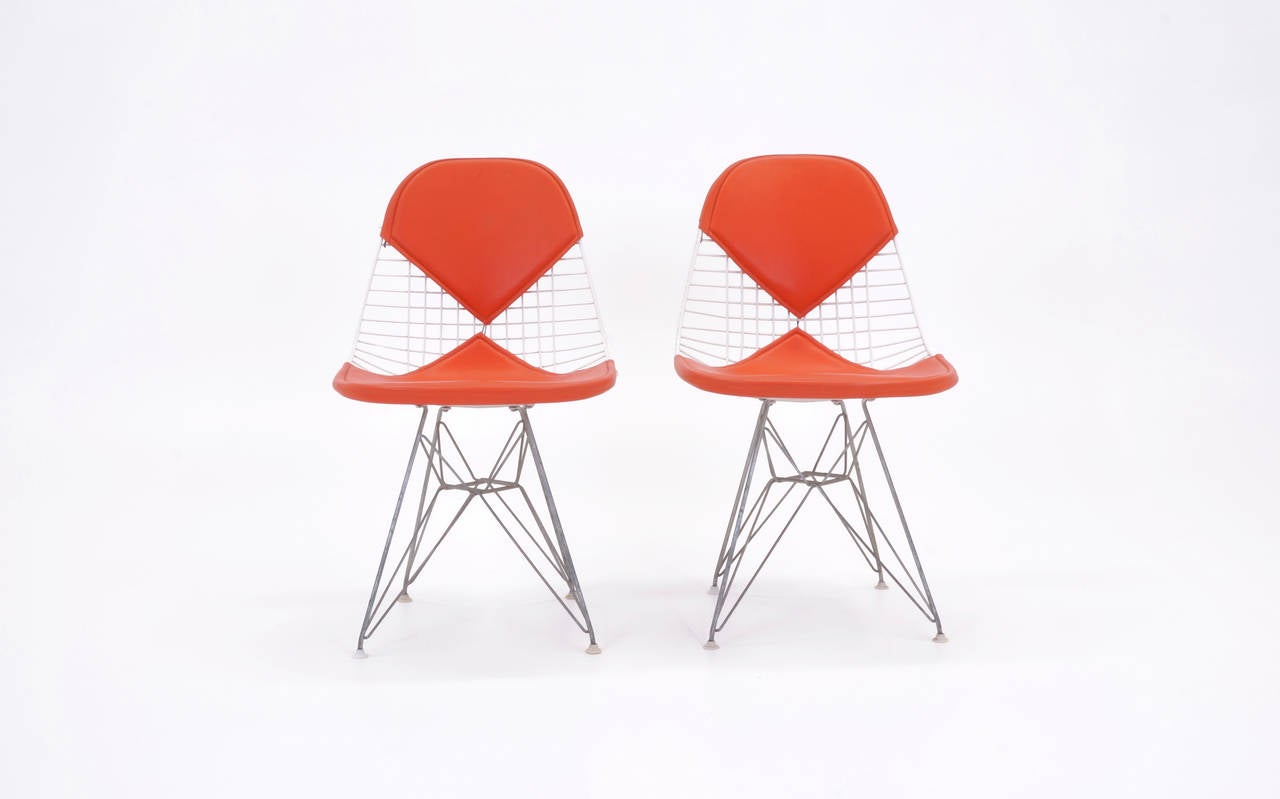 Excellent, all original Charles and Ray Eames white wire chairs on zinc Eiffel tower bases. Original Alexander Girard Vinyl. Great color combination.