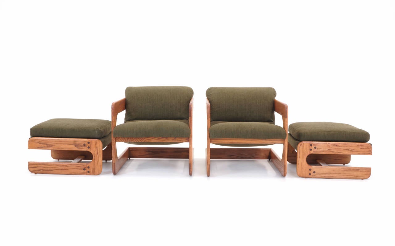 Pair of Lou Hodges designed cantilever chairs and ottomans. Oak frames and new upholstery. Look great and very comfortable.
Chair dimensions: Height 15.5