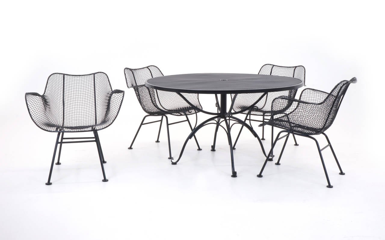 Expertly media blasted and powder coated in a black satin finish, this is a stunning patio set designed by Russell Woodard, circa 1950s.

Table 26