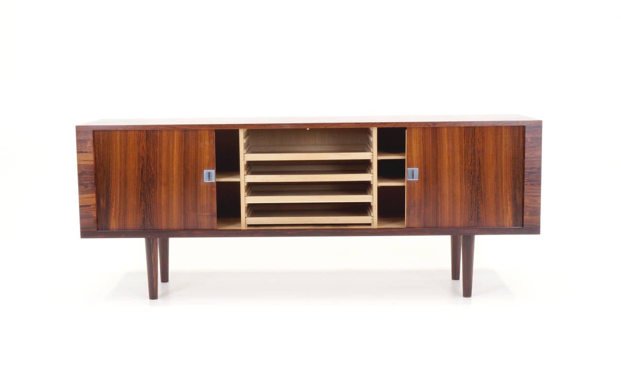 Excellent example of the Hans Wegner President credenza. Beautifully figured Brazilian rosewood exterior with maple interior. A truly stunning piece sure to only appreciate in value.