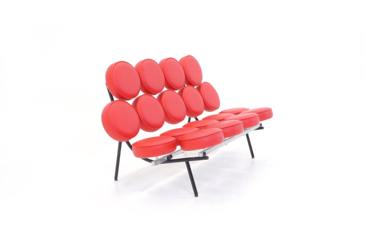 Designed by Irving Harper for the Nelson office, this is a recent production red vinyl George Nelson Marshmallow sofa in excellent condition.
