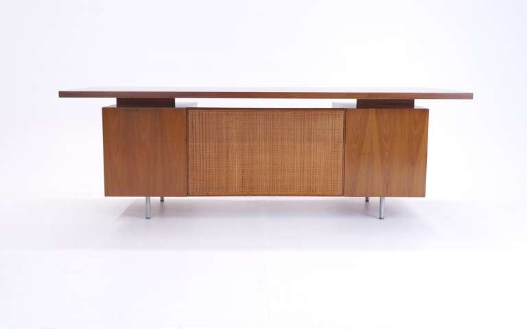 1960s Walnut George Nelson for Herman Miller desk. Floating top, single row brushed steel legs. Signed with the round metal 1960s medallion.