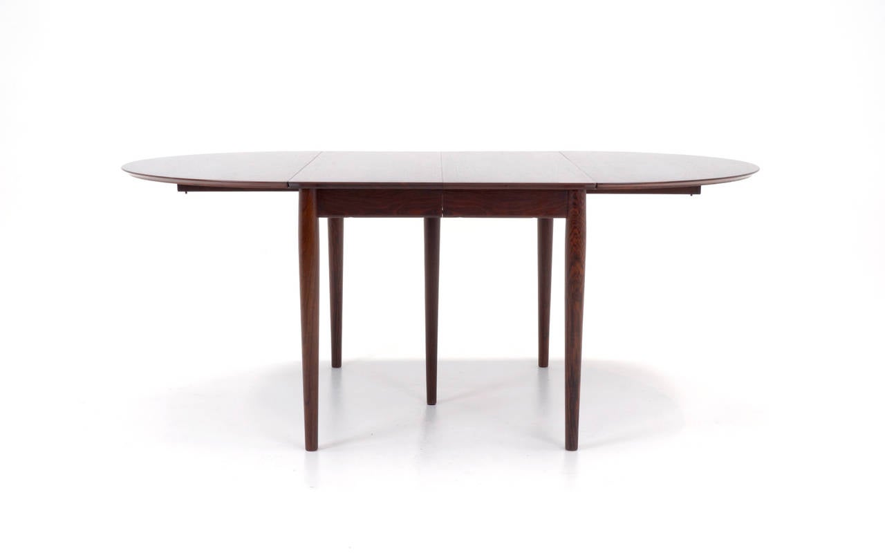 Stunning Brazilian rosewood drop-leaf dining table designed by Arne Vodder. Begins as a small table for two, 30
