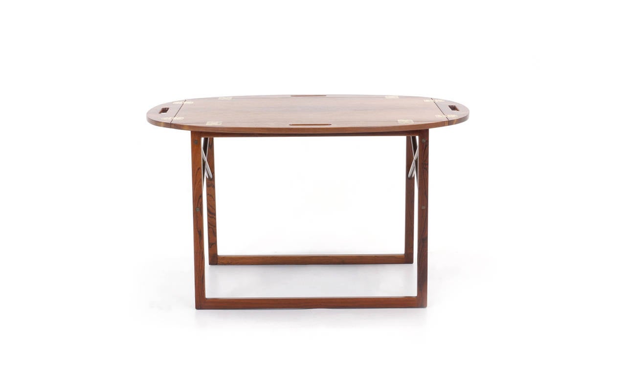All original, excellent condition tray table (removable tray) in Brazilian rosewood with brass cross stretchers. Danish modern design by Svend Langkilde for Illums Bolighus. Quick shipping. $250.00 in the Continental U.S via Fedex.