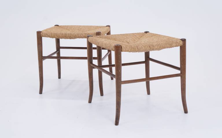 Striking pair of stools with rush seats and walnut legs. In excellent original condition. Shipping in the Continental US only $100 for the pair.