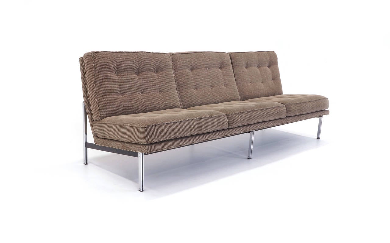 Florence Knoll armless sofa with button tufted seat and back.