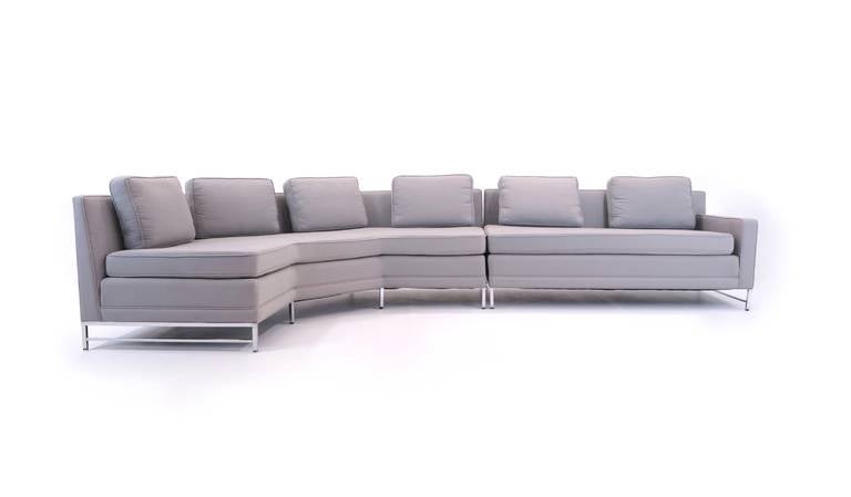 Paul McCobb two piece sectional sofa with nickel plated brass legs and frame.  This sofa was reupholstered approximately 15 years ago and shows minor signs of wear.  The color is a light gray.
