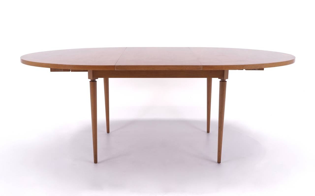 Beautiful bleached mahogany oval dining table designed by Robsjohn - Gibbings for Widdicomb.  Signature Gibbings detailing on the legs and table top.  Table is 60.25 inches long with one 20