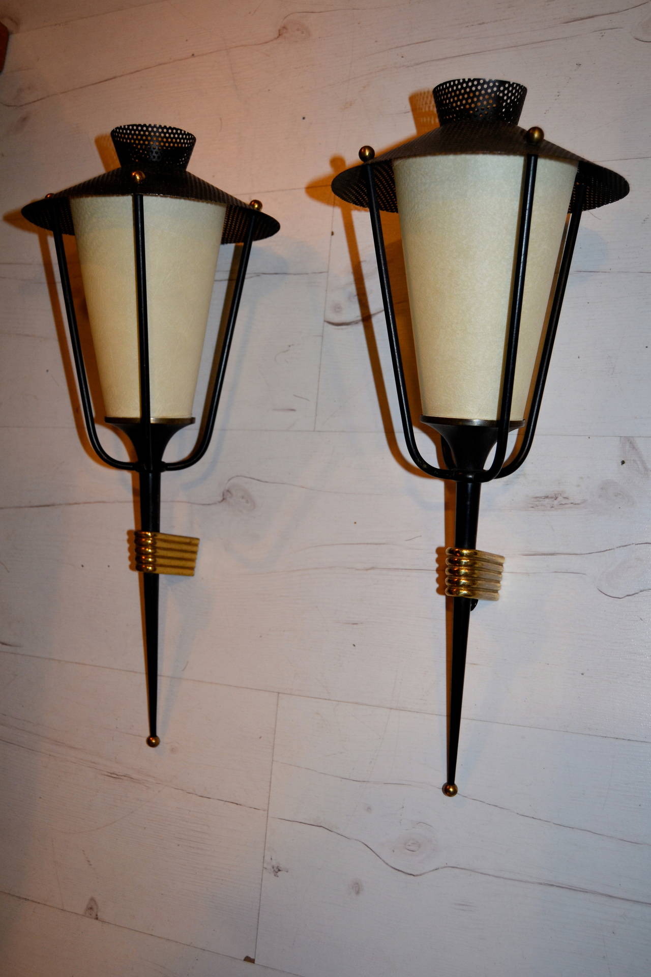 A pair of vintage 1950s  French wall mounted lantern-form fixtures in brass black lacquered  and perforated metal.Original shade in perfect condition
designed by arlus