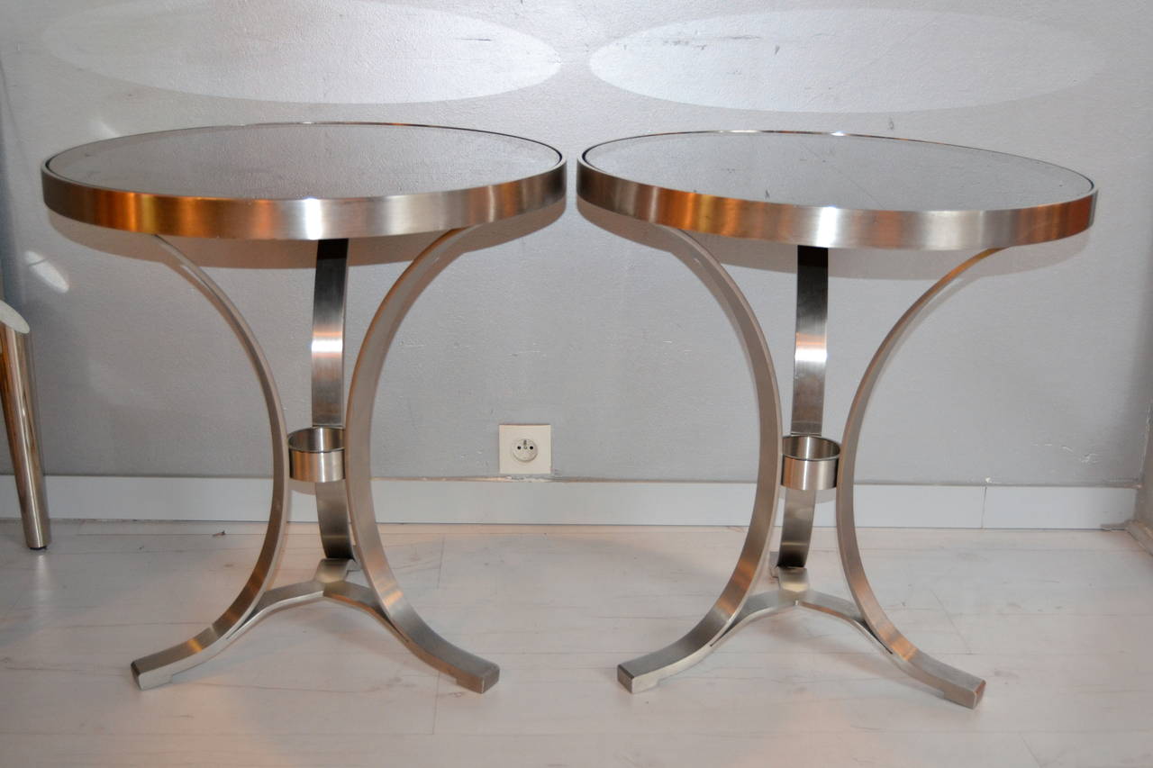 Pair of 1970s round side tables in nickeled steel with black glass top and three in curving legs, France.