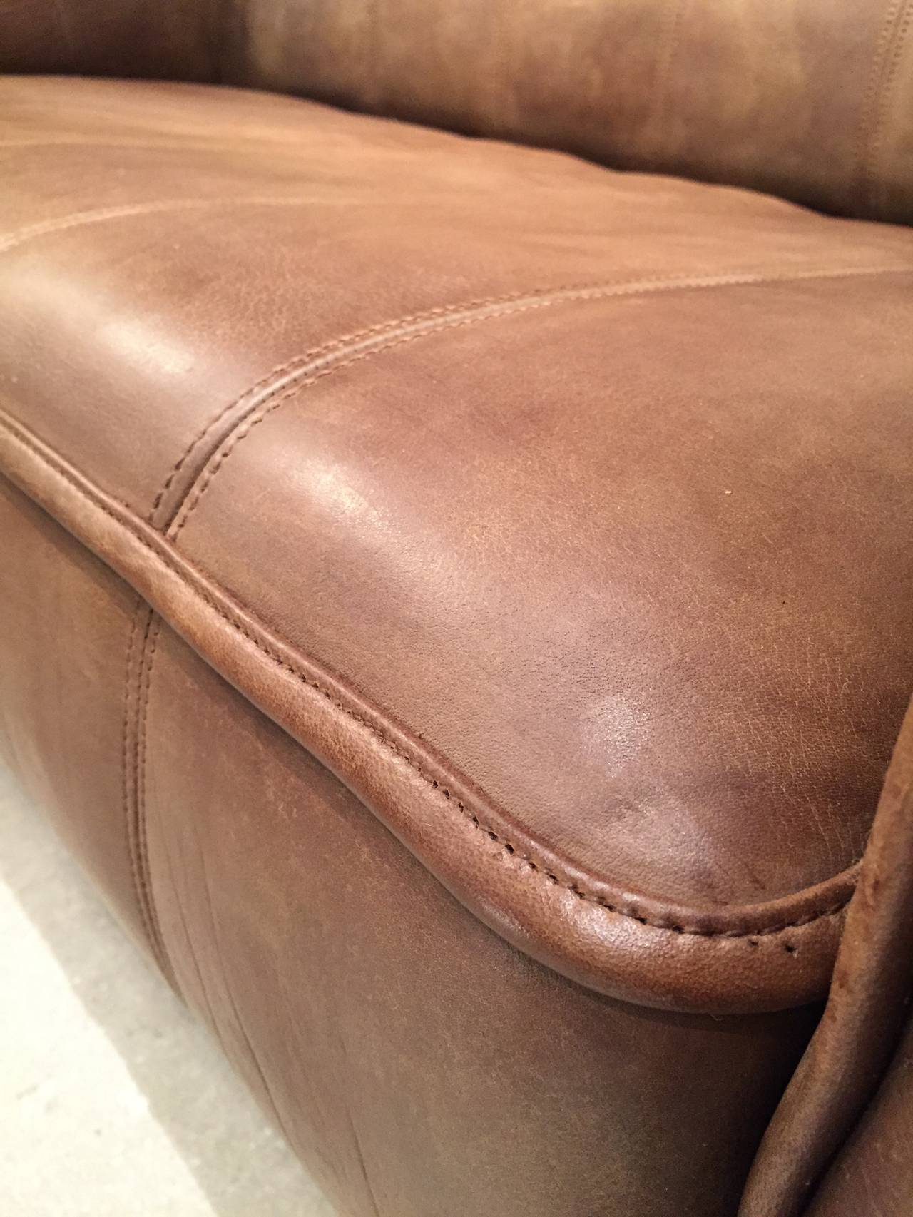 Nice and perfect condition DS44. Two-seat sofa. Heavy wooden frame design featuring additional steel frame, brown saddle leather coverings. The seat may be pulled out. 
Very high quality buffalo leather.
From the same series a three-seat sofa and