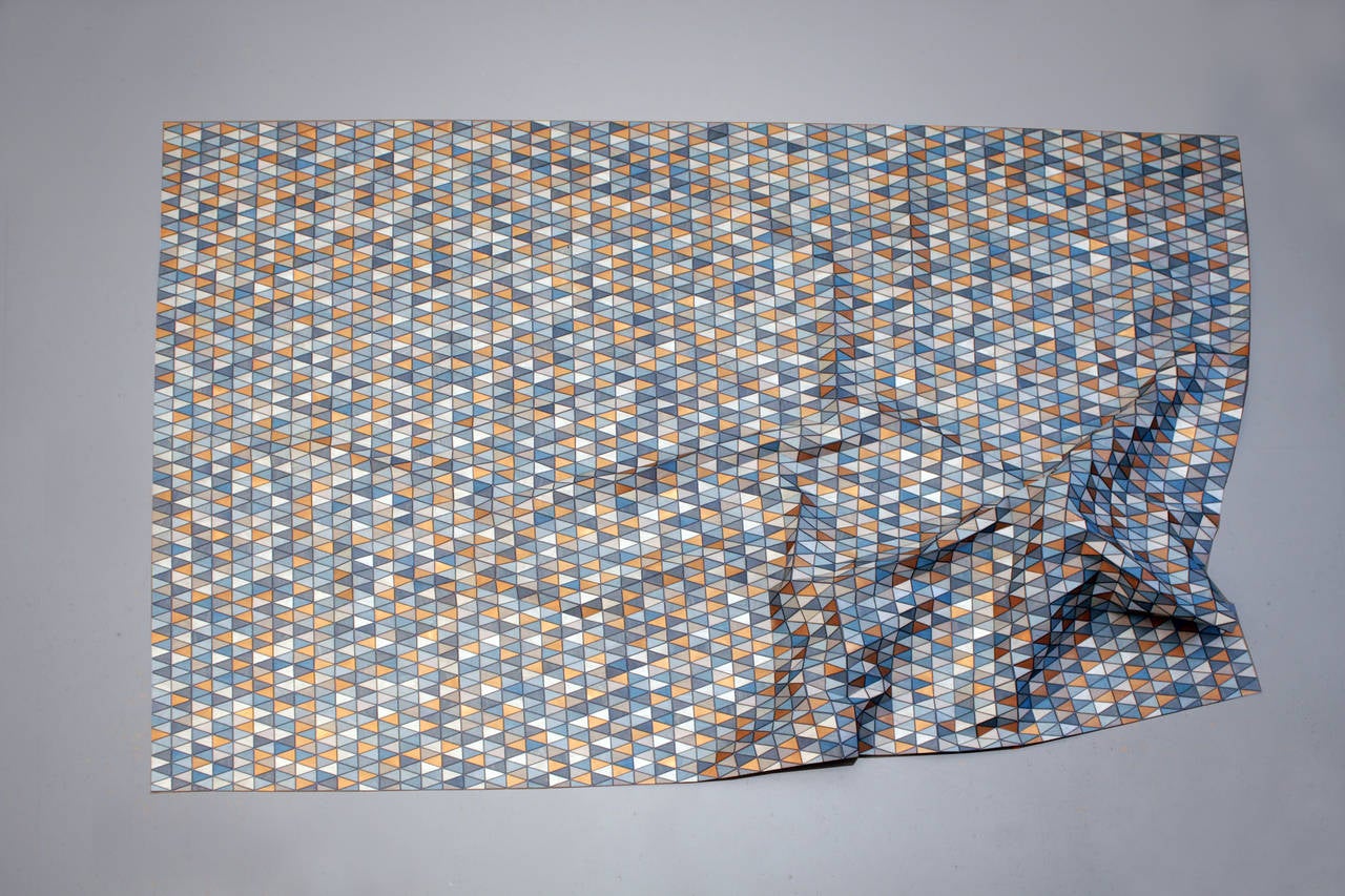 The rug “Reflecting Blue” from the series “Colored Wooden Rugs” brings together the subtle texture of thin wood veneer on textile backing with the rippling, shifting colors of individual triangular paillettes. By introducing color to her “Wooden