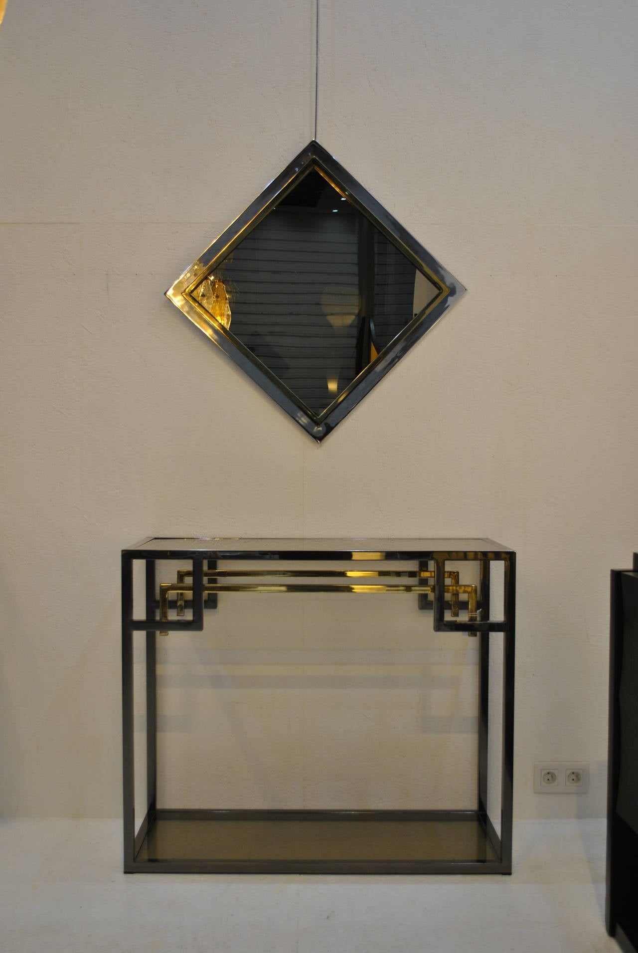 A nice chrome, 24-karat gold-plated and smoked glass console table by Belgo Chrom / Dewulf Selection, Belgium.

Belgo Chrom is a Belgian high-end furniture manufacturer that started making this type of pieces in the early seventies.
With its high