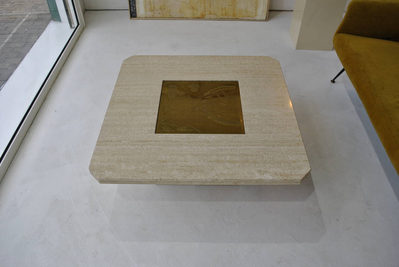 A great rare coffee table by the Belgian artist Georges Mathias from the late 1970s.
Base and top in travertine marble and an inlaid etched brass plate with stylized 'Rising Sun with Bamboo' design, a very known design by Georges Mathias.
The