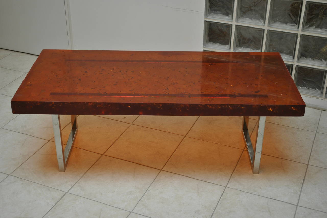A large, sleek and very nice amber colored fractal resin coffee table by Henri Fernandez on a steel base. Signed and dated 1972.

Espace Camille presents a group of rare and nice pieces coming from the private collection of the French artist Henri