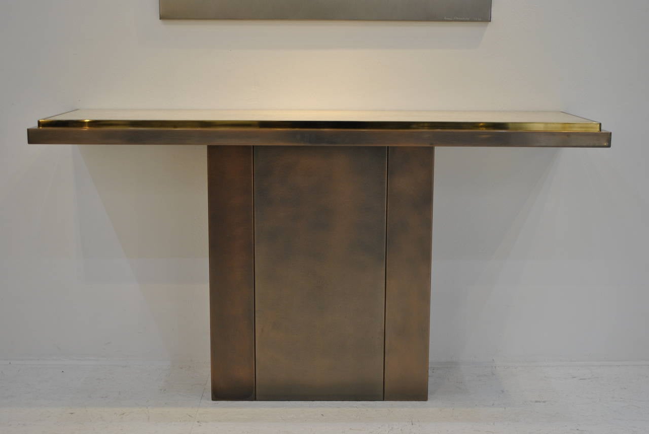A very example of pure Belgian high-quality design, this bronze patinated steel console has very nice 24-karat gold plated accents and is finished with a Persan travertine marble top. Very good condition.

The matching entirely 24-karat gold