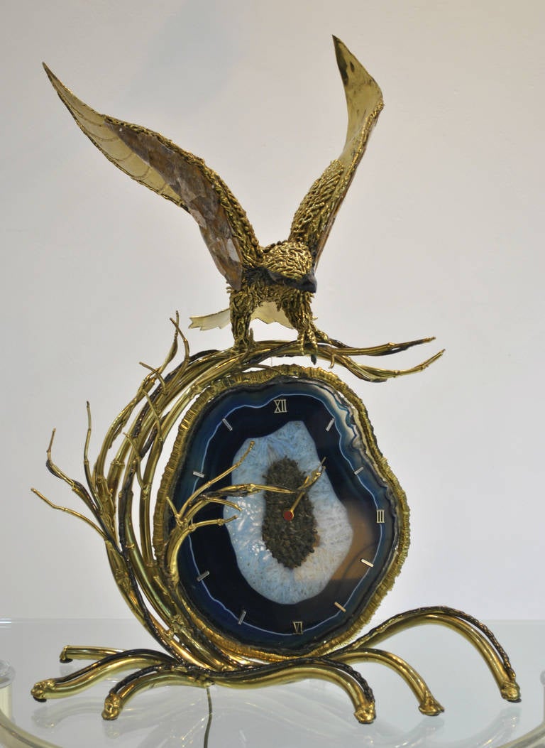 Extremely well realized large mantel or table clock made by Richard Faure for Honoré Paris in the early 1980s.
This one-of-a-kind masterpiece is entirely handmade out brass, a large agate and silicon by the artist.
The agate and the wings of the
