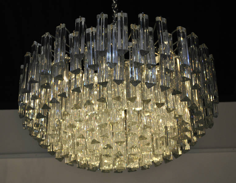 A stunning and sophisticated pair of Camer Venini chandeliers. Nine tiers of good condition triedri prisms.
Very good large size (70 cm x 37 cm). Old edition dating from the 1970s.

FREE SHIPPING to Continental Europe, UK, Canada and USA is