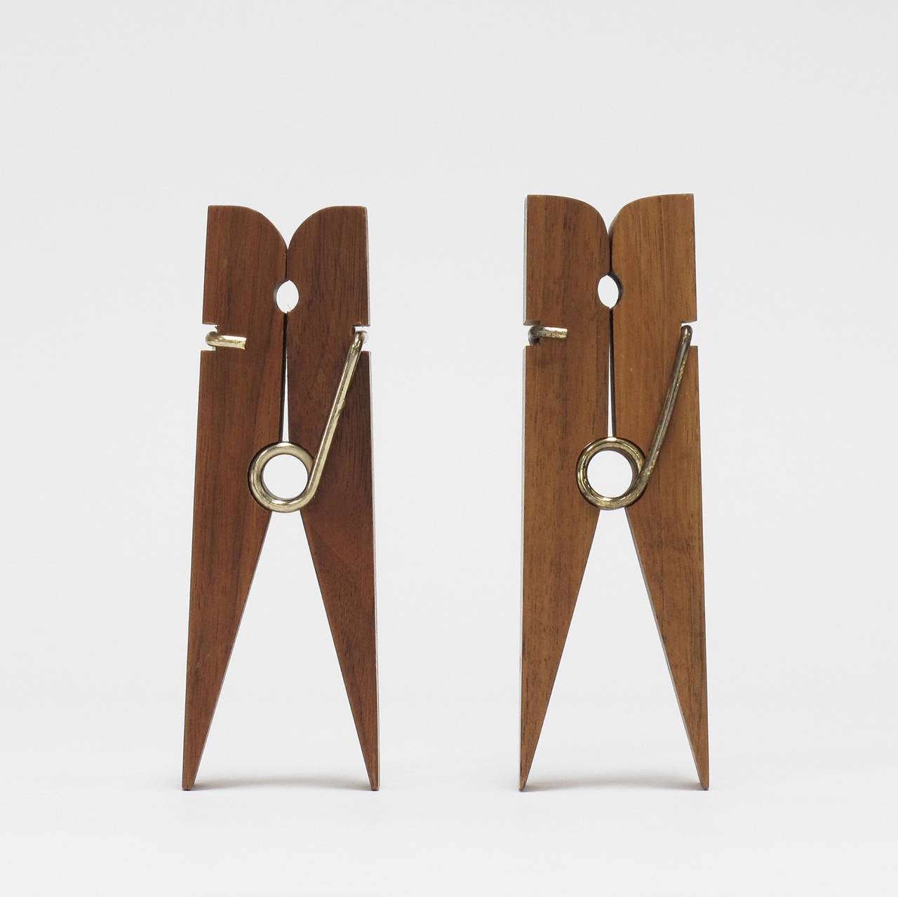 Pair of solid wood and brass oversized clothespins, American, 1970s, good vintage condition.