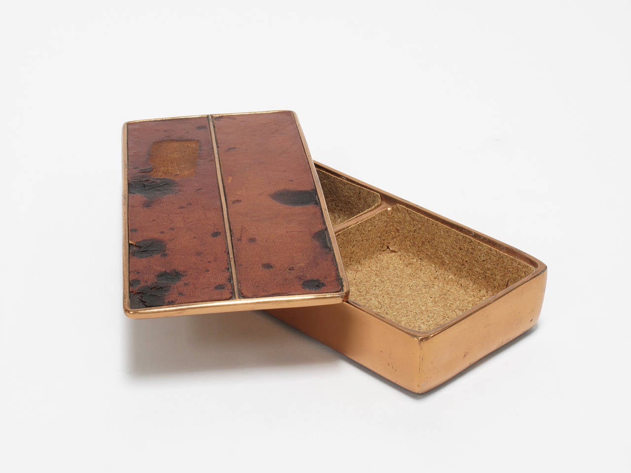 Copper-plated, cork lined metal box with two storage compartments, copper lid with inlaid leather. Handsome keepsake container for trinkets, jewelry and coveted objects. Designed by Ben Seibel and made by Jenfred Ware, New York, 1950s.
