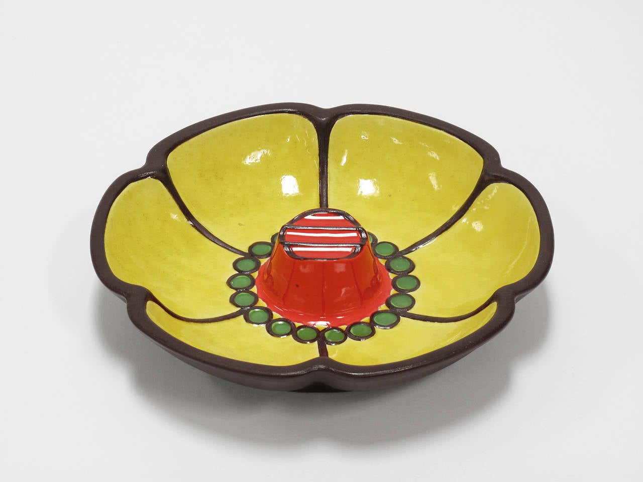 Colorful hand decorated, glazed ceramic dish, part of the contemporary collection designed exclusively for Haeger by Ben Seibel, celebrating "the look of today with youth appeal." An exclusive import, marked on bottom "Haeger,"
