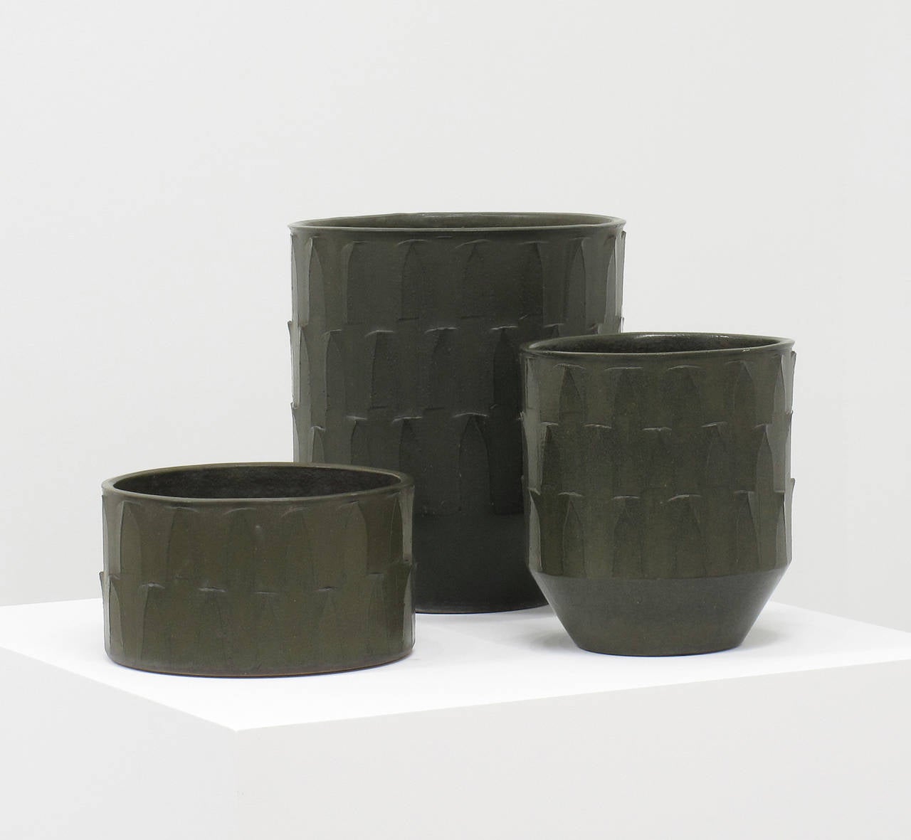 David Cressey
Collection of three 'ribbed' design ceramic planters
Stoneware, dark olive glaze
Pro Artisan Collection
Architectural Pottery
Los Angeles, California, 1960s

16  high x 14 diameter inches (40.6 high x 35.6 diameter cm)
12 high