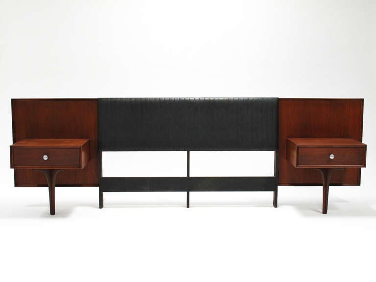 Full size walnut headboard, backed with a black naugahyde headrest embossed with a vertical faux stitch pattern, flanked by two floating nightstands with drawers, designed by Robert Baron and made by Glenn of California, USA, 1960's, good vintage