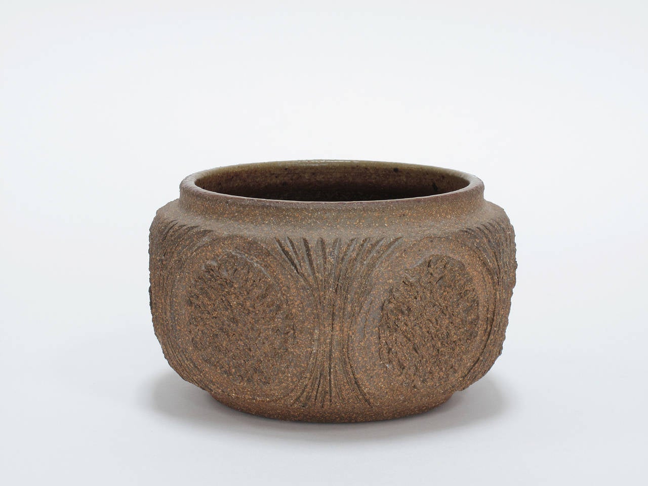Stoneware vessel with an unglazed, hand-incised exterior design and a speckled, ochre-moss glazed interior, made by Robert Maxwell, California, 1960s, signed by the artist.