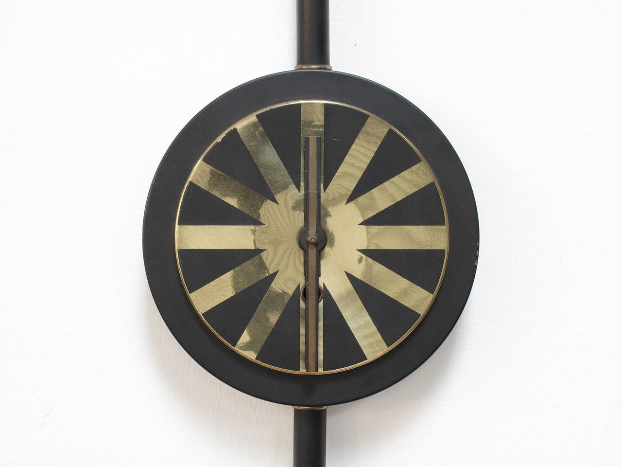 Modernist wall clock in brass and metal, made in Germany, 1957

In the style of an asterisk wall clock by George Nelson & Associates, this wall clock echos the Werner Wersktatte and Hagenhauer design movements with its contrasting black