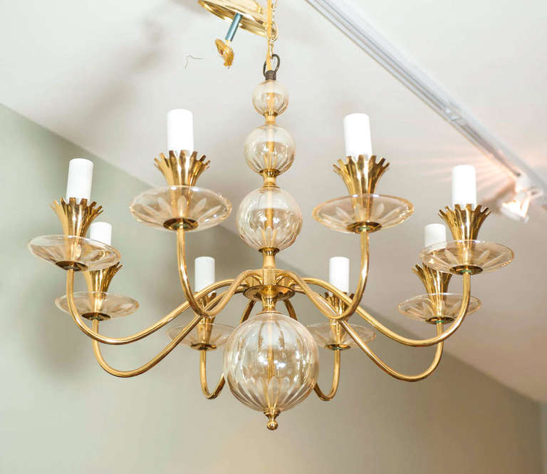 A modernist chandelier with a shimmering etched glass ball centre column.