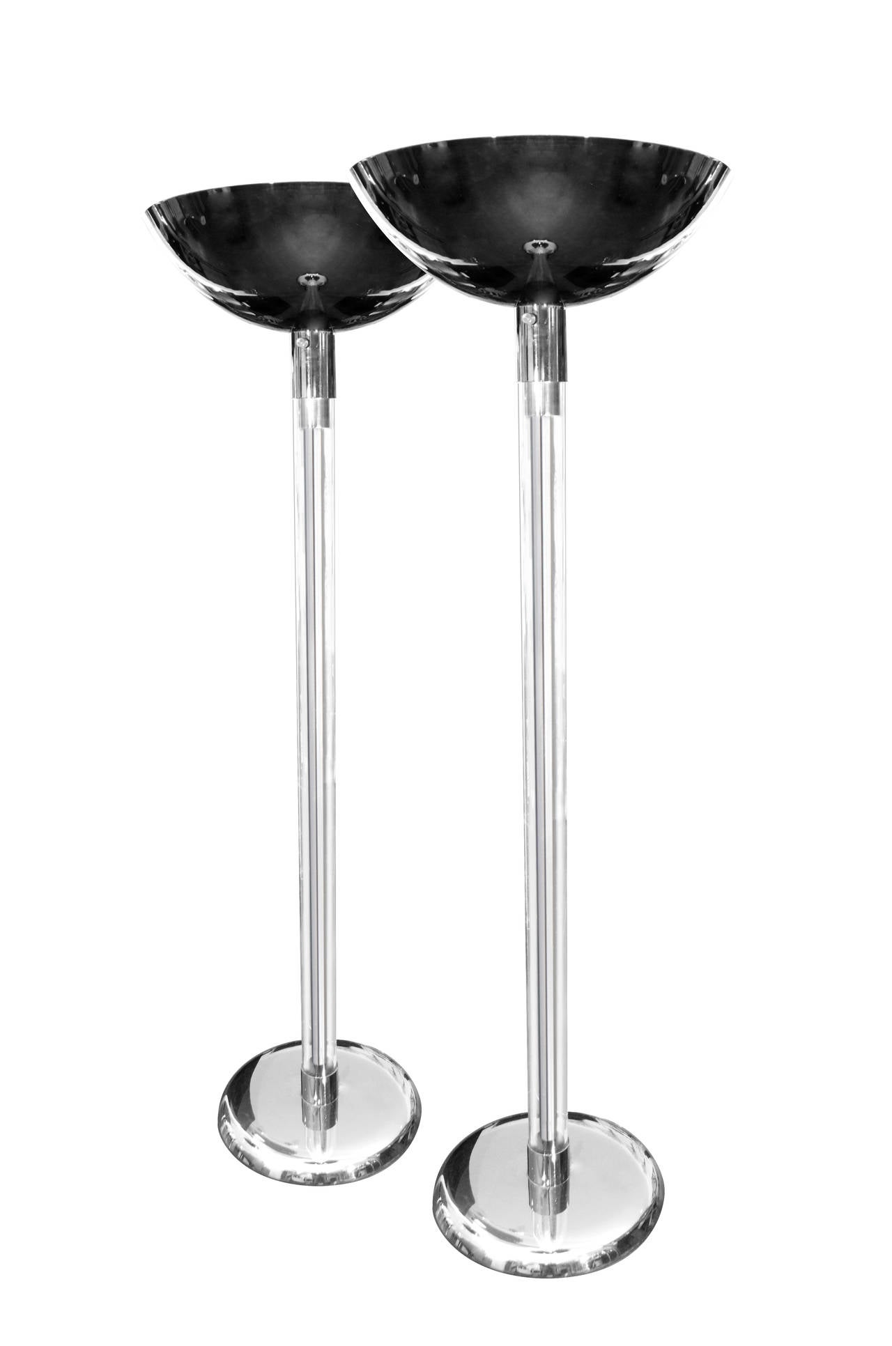 Rare pair of grandly scaled torchiere floor lamps by Karl Springer, circa 1970s. Plated in polished gunmetal with Lucite sheathing on the center columns. Very, very good condition.