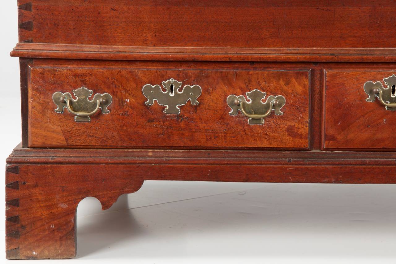 This finely crafted blanket chest of drawers is distinguished by the open dovetailing of the case, this following from the sides through the feet to accentuate the hand crafted nature of the object.  Pennsylvania craftsmen during the late 18th