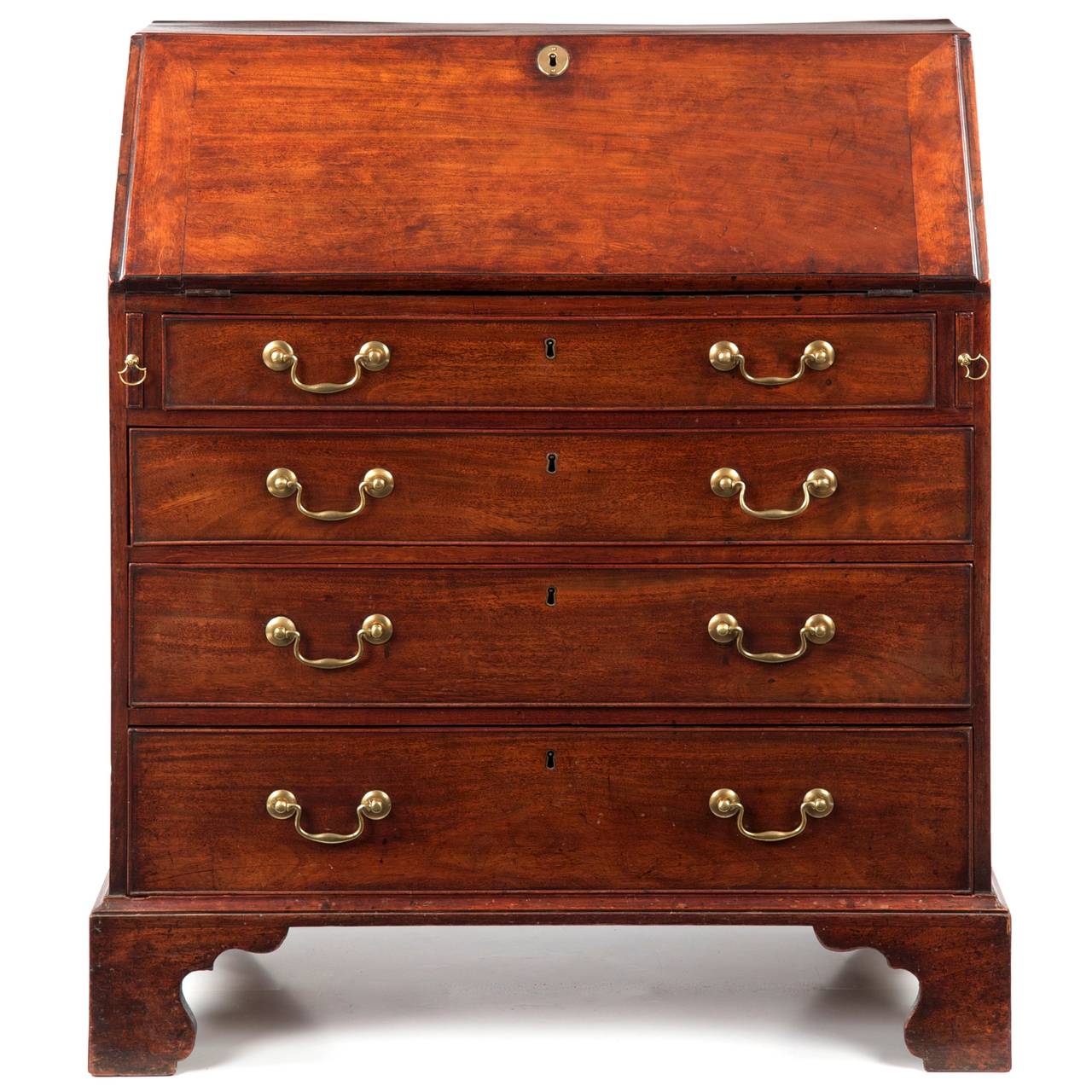 This fine antique English George III slant front desk is noteworthy for it's very attractive proportions, having a more slender frame than many of the desks of the period.  It is an object that does not impose itself on a room, but rather it's