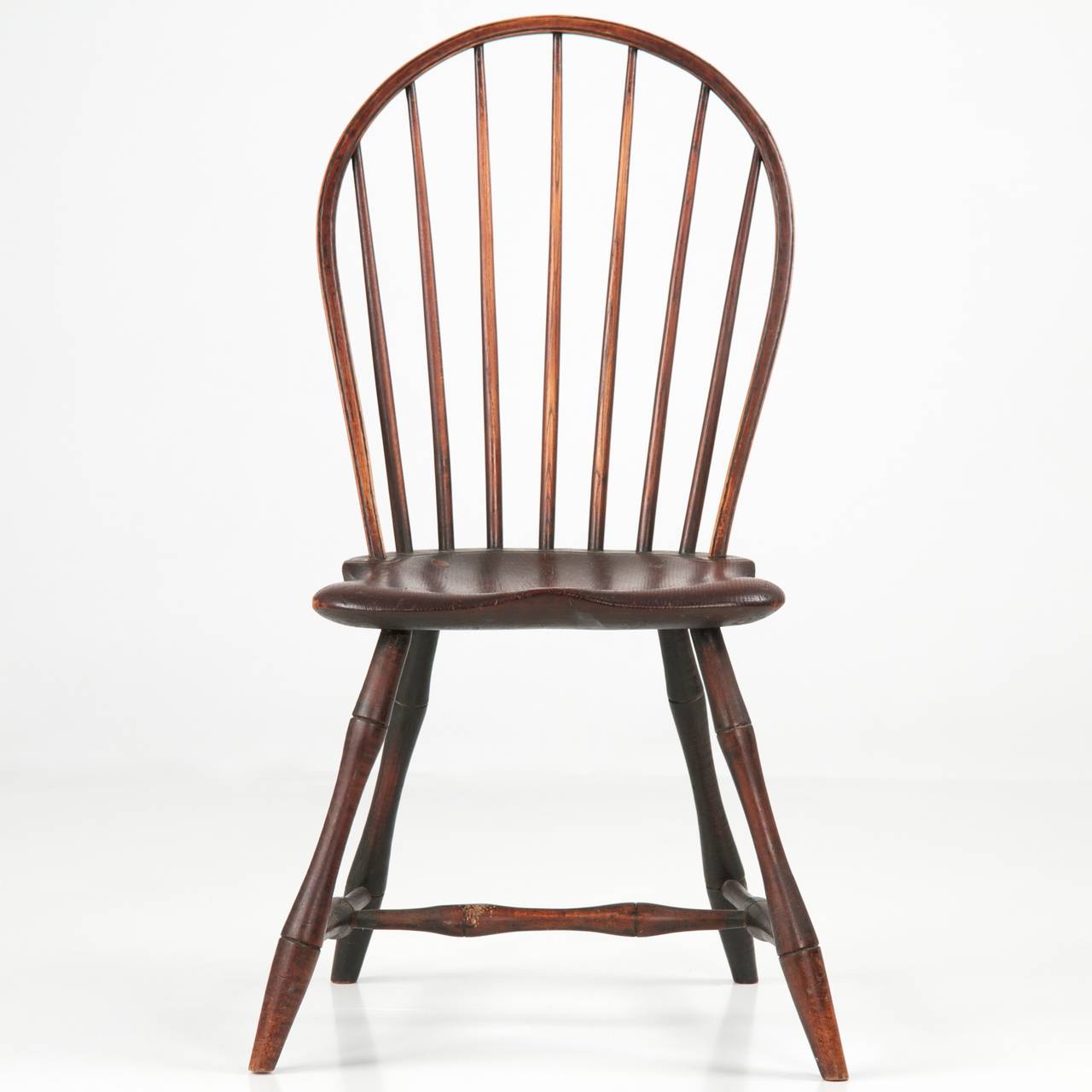 A very well preserved piece of early 19th century material culture, this fine American Bowback Windsor side chair originates from Pennsylvania during the first years of the century, probably the outskirts of Philadelphia c. 1800-10.  Retaining an