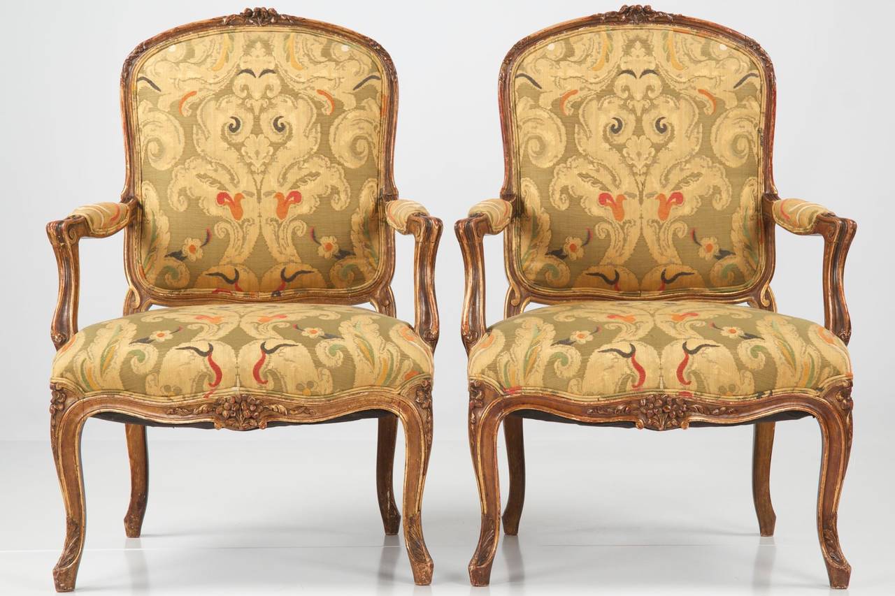 This is an inordinately well executed pair of fauteuils in the Louis XV taste.  Probably crafted during the mid-to-late 19th Century, the chairs are built to last the test of time with pegged tenon-mortised joinery in much of each chair.  The crest