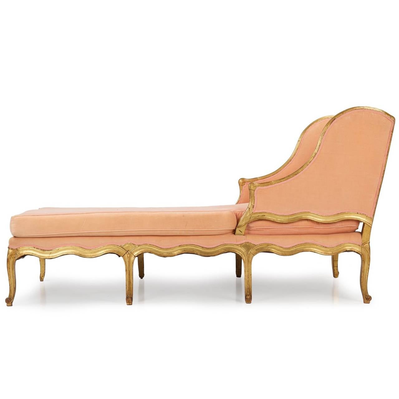 This large and unique chaise longue was probably crafted during the first quarter of the 19th century, the shapely design contrasting the angularity of the seat against an almost unending undulation in the frame. The curvy form is emphasized by the