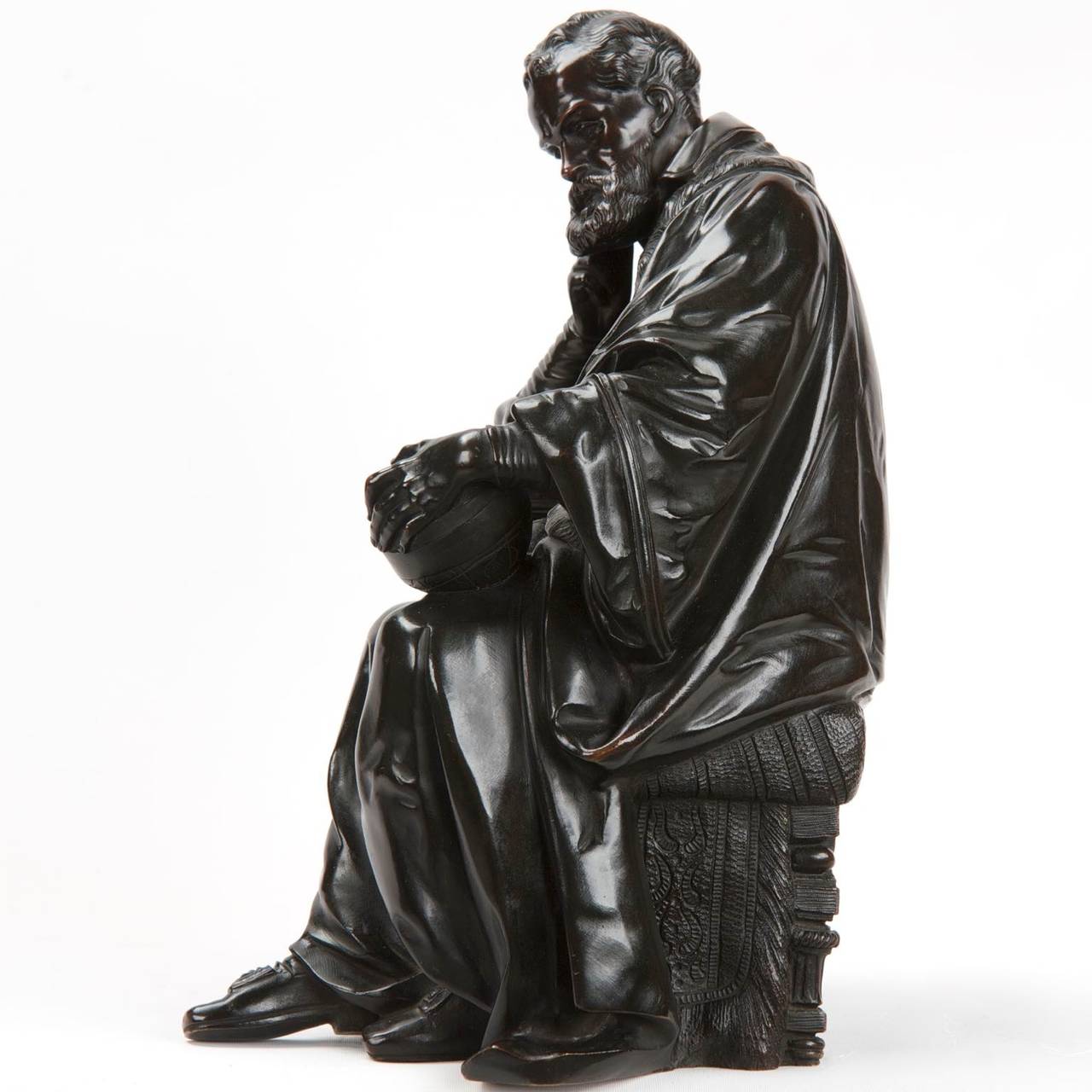 This exceptional antique French bronze sculpture captures the astronomer Galileo surrounded by thick leather bound volumes tucked into the ornate bookshelf he leans upon, his brow furrowed and deep in though as he gazes deeply into the globe