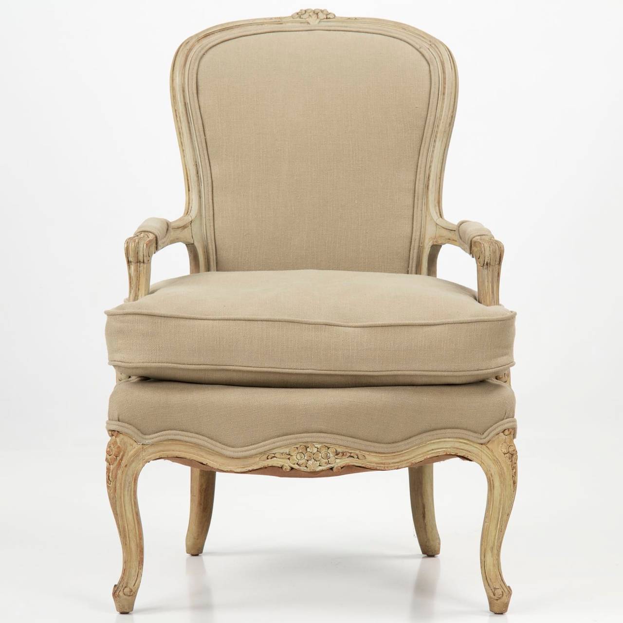 The Provincial form of this chair is nicely complimented by the gray linen upholstery, this a new covering we selected for the chair; the stuffed cushion is filled with down feathers and the chair is very comfortable. The surface has been touched up