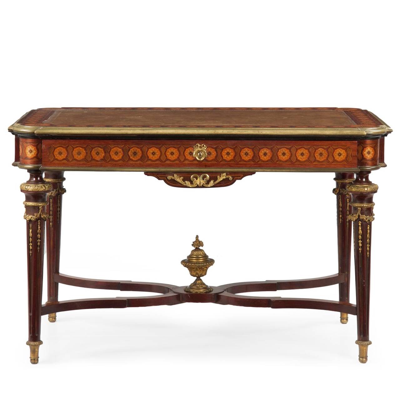 With some of the finest marquetry inlays, this exquisite bureau plat is a defining piece for the study. Exhibiting clean and delicate neoclassical lines, the form is light and airy with it's tapering legs that rise from brass capped feet into bold