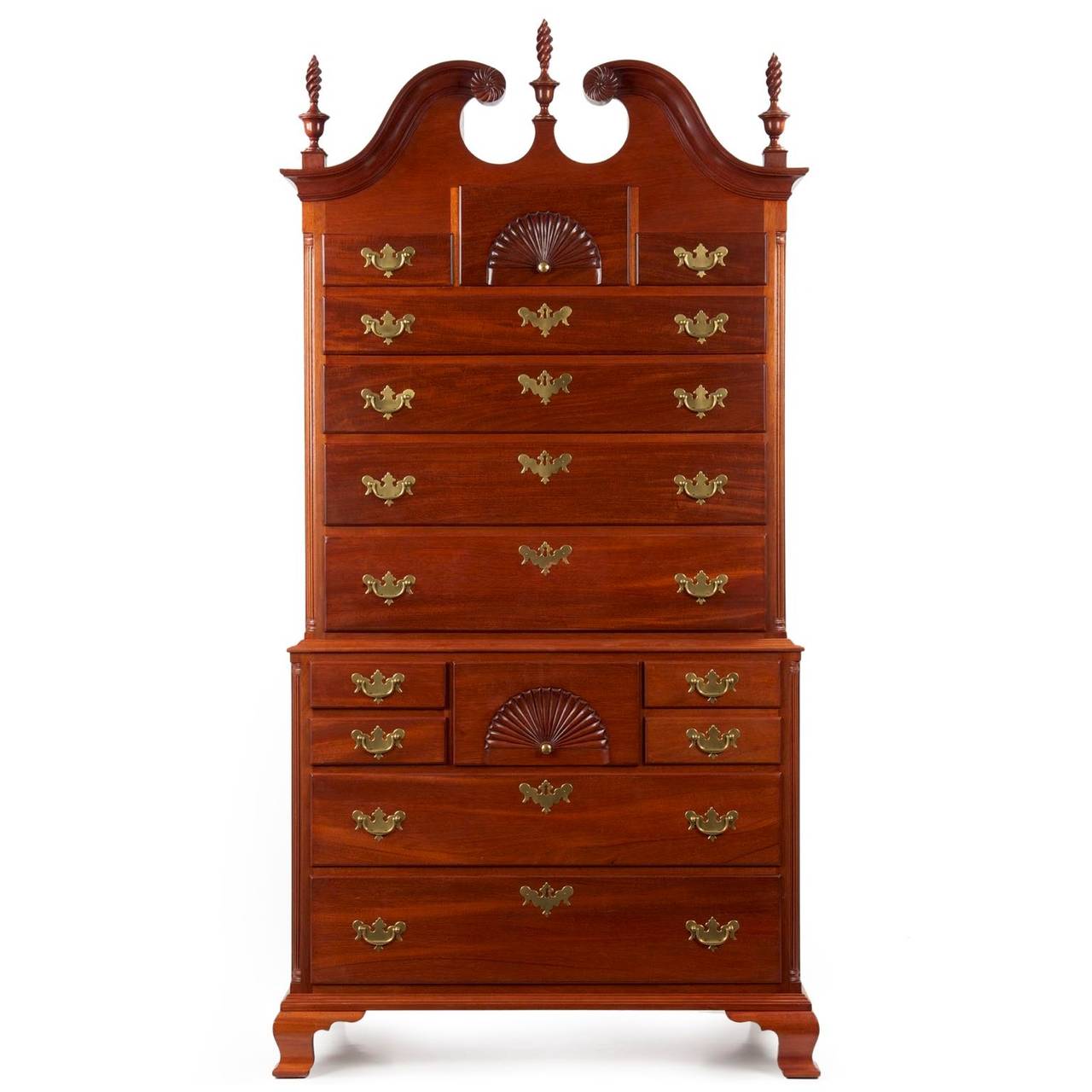 Attention to period detail is noteworthy in this fine case piece. Crafted in the manner of the Connecticut River Valley examples of the late 18th Century, the chest on chest features bold fluted corner columns in both upper and lower cases flanking